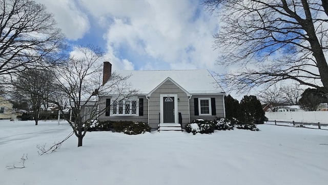 view of front of house featuring a chimney and fence