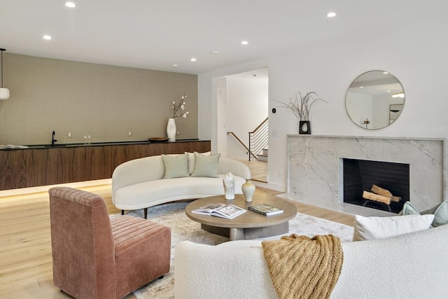 living room featuring wood finished floors, recessed lighting, and a fireplace