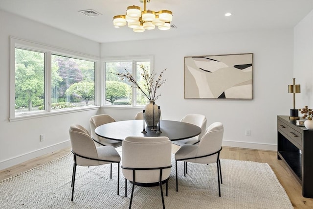 dining space with a chandelier, light wood finished floors, baseboards, and recessed lighting