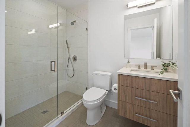 full bathroom featuring a shower stall, toilet, vanity, and tile patterned flooring