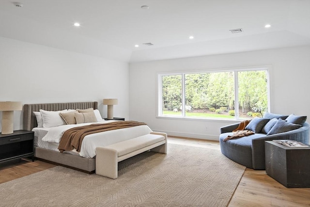 bedroom with light wood-style flooring and recessed lighting