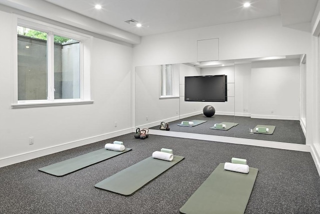 workout area featuring baseboards and recessed lighting