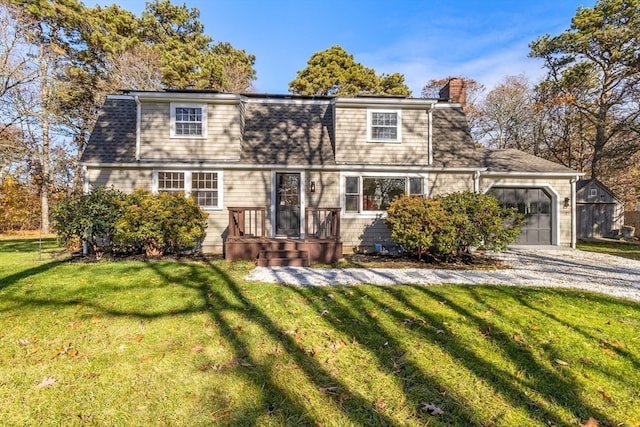 view of front of home with a garage and a front lawn