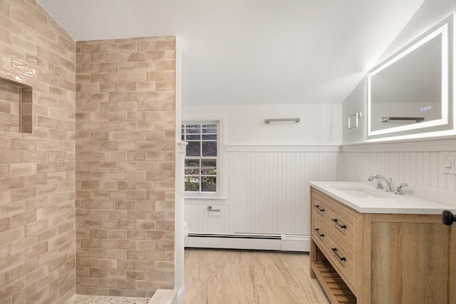 bathroom featuring vanity, baseboard heating, and lofted ceiling