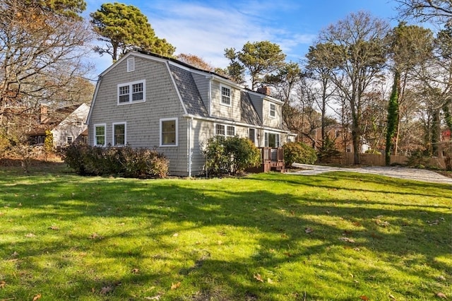 rear view of house featuring a yard