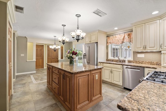 100 Avery Heights Dr, Holden, MA 01520 - kitchen featuring cream cabinets, stainless steel appliances, a chandelier, light stone countertops, and tasteful backsplash