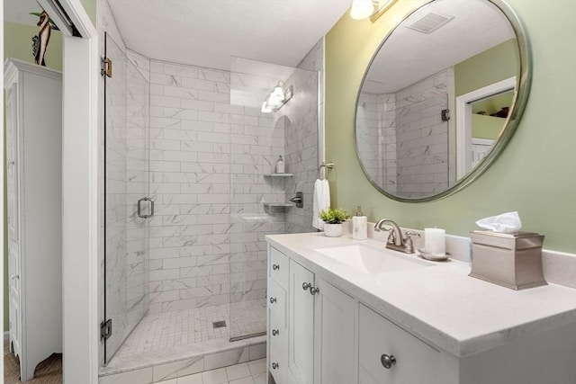 full bath with a stall shower, visible vents, and vanity