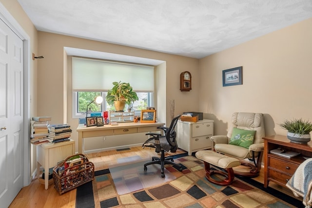 office space with light wood-type flooring