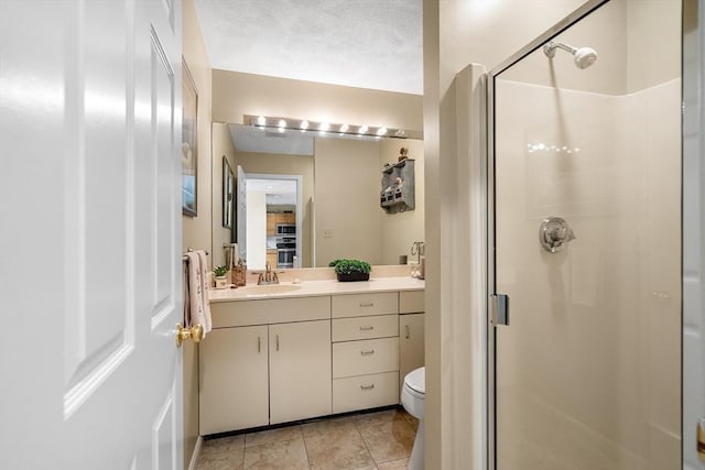 full bath with a stall shower, tile patterned flooring, vanity, and toilet