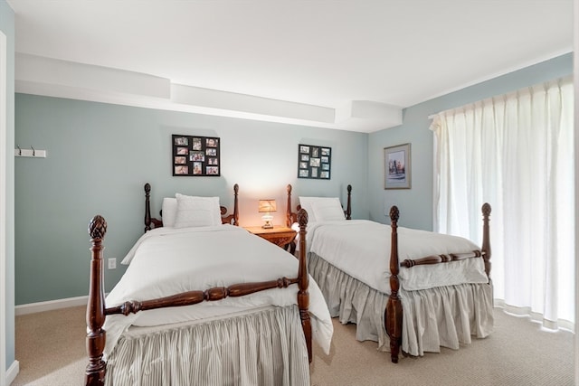 carpeted bedroom featuring multiple windows