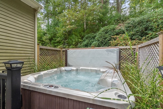 wooden deck featuring a hot tub