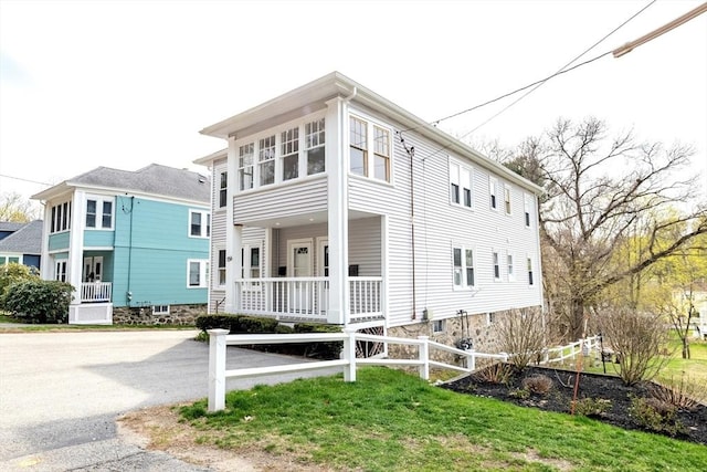 view of front facade with fence and a porch