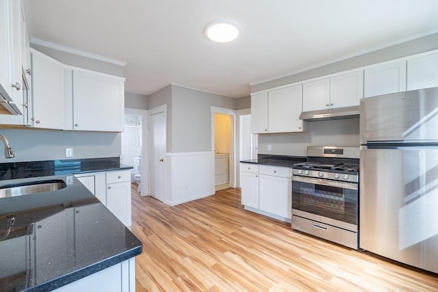 kitchen featuring a sink, stainless steel appliances, white cabinetry, and under cabinet range hood