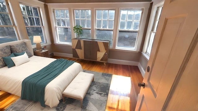 bedroom featuring baseboards and wood finished floors