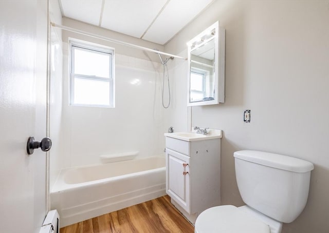 full bathroom featuring vanity, toilet, shower / bath combination, wood finished floors, and a baseboard radiator