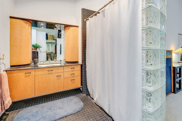 bathroom with vanity, curtained shower, and tile patterned flooring