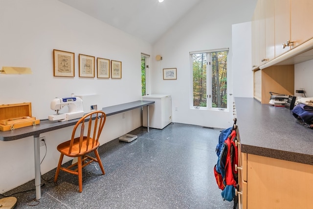 office area with built in desk and lofted ceiling