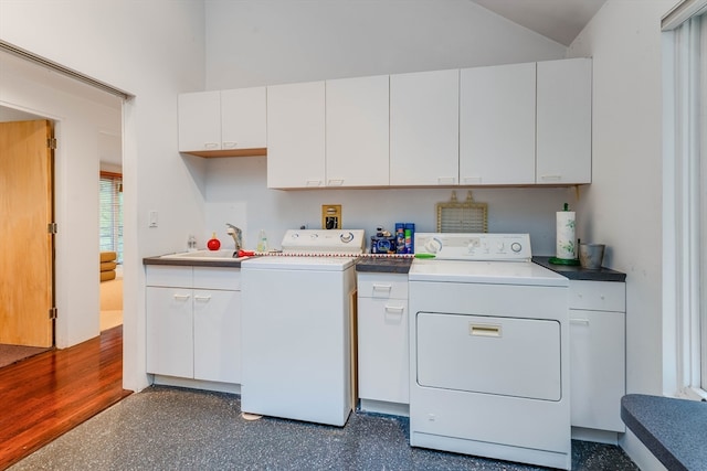 washroom with sink, independent washer and dryer, dark hardwood / wood-style floors, and cabinets