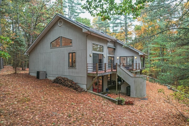 back of house with central AC and a deck