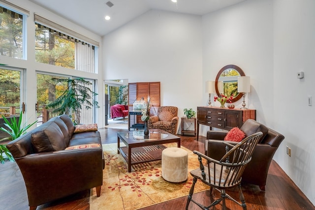 sitting room featuring hardwood / wood-style flooring and high vaulted ceiling