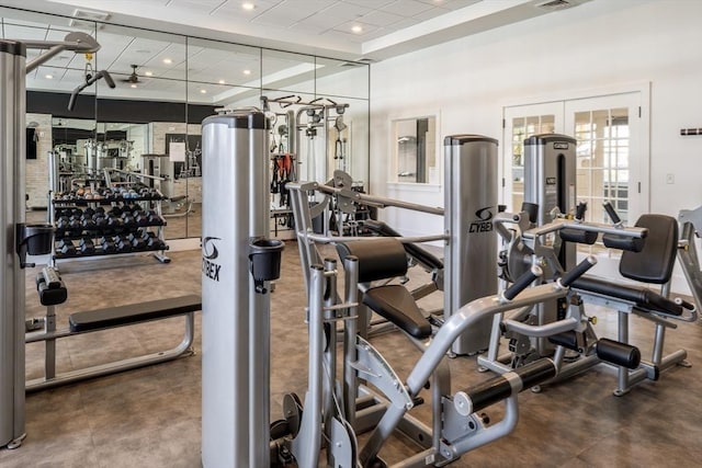 exercise room featuring french doors, a paneled ceiling, and recessed lighting