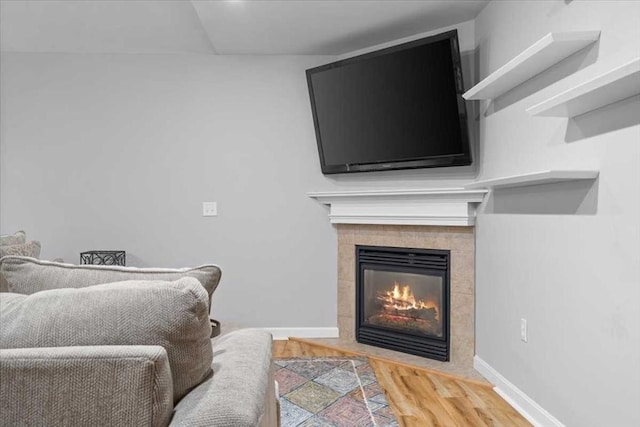 216 Reservoir St # 304, Holden, MA 01520 - living area with a tiled fireplace, wood finished floors, and baseboards