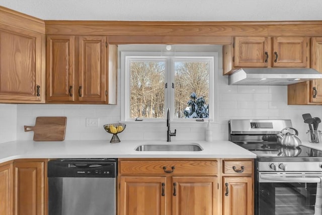 kitchen with sink, decorative backsplash, appliances with stainless steel finishes, and extractor fan