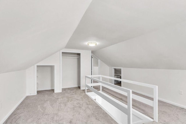 bonus room featuring light colored carpet and vaulted ceiling