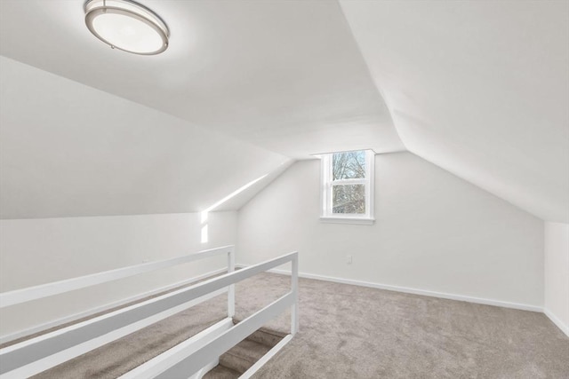 bonus room featuring carpet and vaulted ceiling