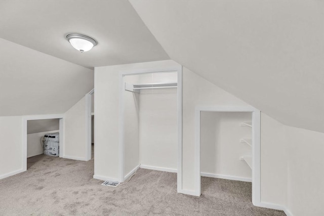 bonus room with light colored carpet and lofted ceiling