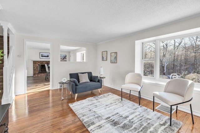 living room featuring a fireplace, hardwood / wood-style floors, and a textured ceiling