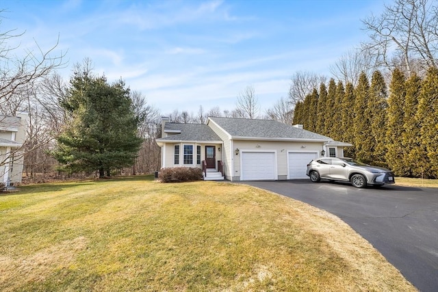 ranch-style house featuring a front lawn, roof with shingles, a chimney, a garage, and driveway