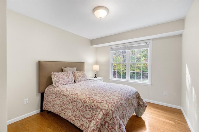 bedroom featuring baseboards and wood finished floors