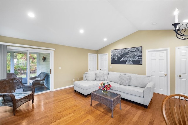 living room with light wood-type flooring, lofted ceiling, and baseboards