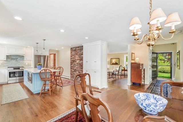 290 Cotuit Bay Dr, Barnstable, MA 02635 - dining area with wood finished floors, a chandelier, and recessed lighting