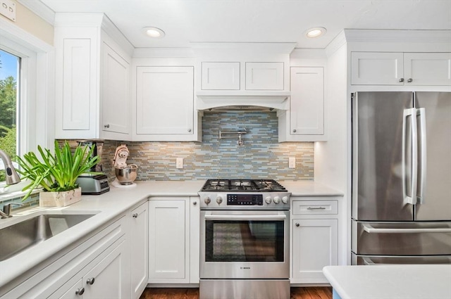 290 Cotuit Bay Dr, Barnstable, MA 02635 - kitchen featuring appliances with stainless steel finishes, a sink, white cabinetry, light countertops, and recessed lighting