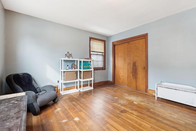 sitting room featuring baseboards and wood finished floors