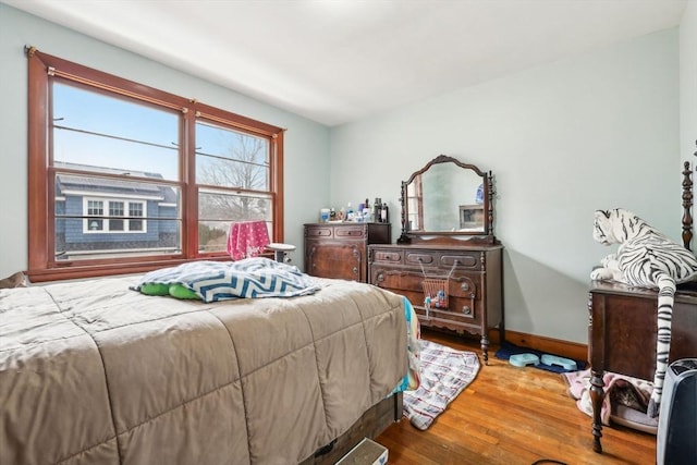 bedroom featuring baseboards and wood finished floors