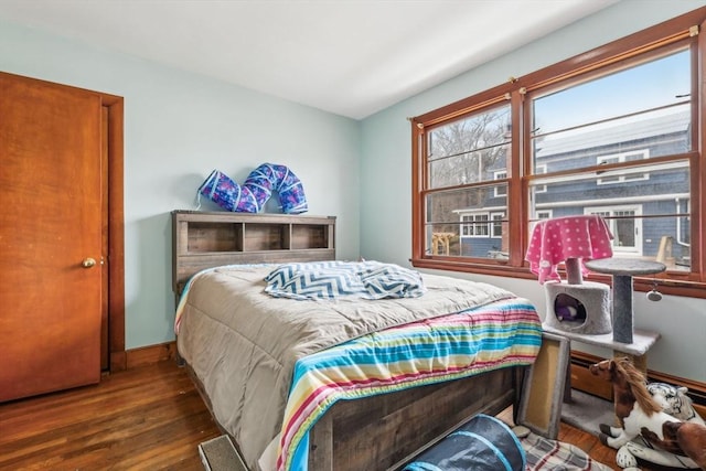 bedroom featuring wood finished floors and baseboards