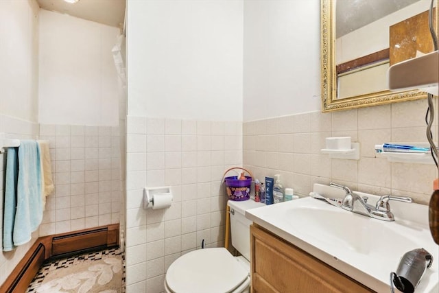 bathroom with toilet, baseboard heating, tile walls, and vanity