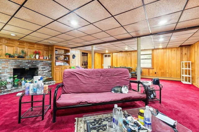 living area featuring a baseboard heating unit, a brick fireplace, carpet floors, and wooden walls