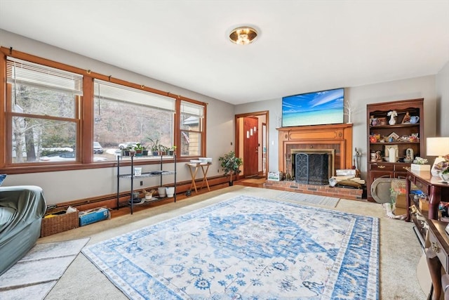 living room featuring carpet, a brick fireplace, and baseboards