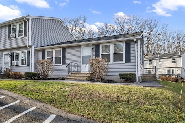 view of front of property with cooling unit and a front lawn