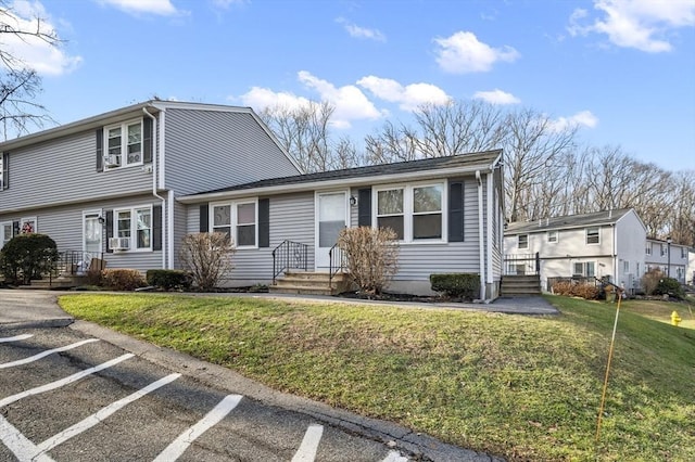 view of front of property with cooling unit and a front yard