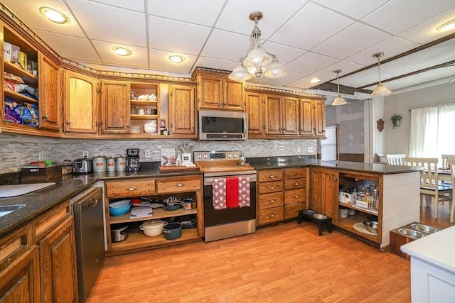 kitchen featuring a paneled ceiling, pendant lighting, backsplash, stainless steel appliances, and light wood-type flooring