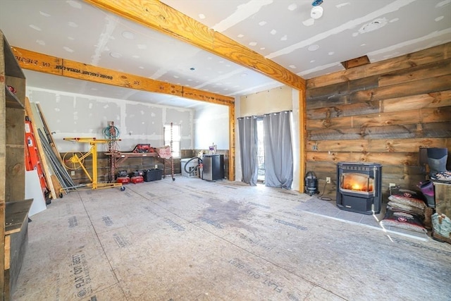 unfurnished living room featuring a wood stove