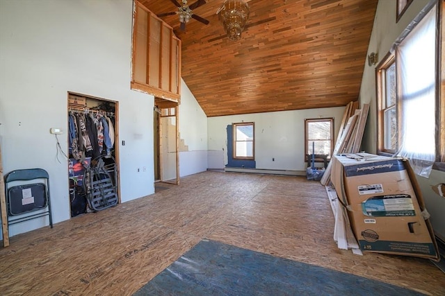 unfurnished living room with ceiling fan, a wealth of natural light, wooden ceiling, and high vaulted ceiling