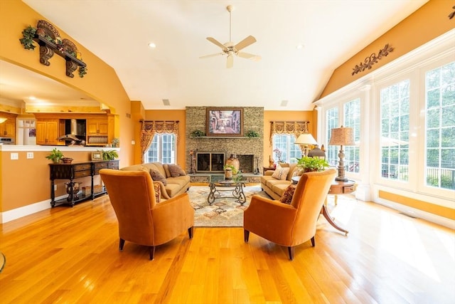 29 Hoveys Pond Dr, Boxford, MA 01921 - living area with vaulted ceiling, light wood-style flooring, a ceiling fan, and a fireplace