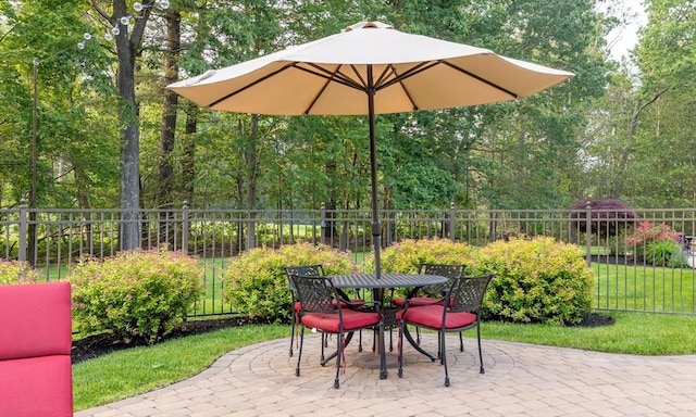 29 Hoveys Pond Dr, Boxford, MA 01921 - fenced backyard featuring a patio area, outdoor dining area, and view of wooded area