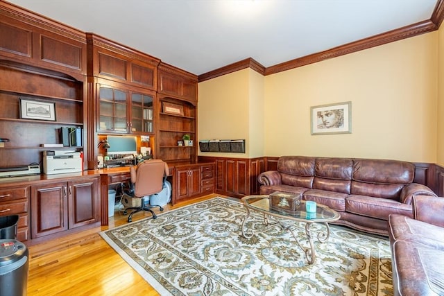 29 Hoveys Pond Dr, Boxford, MA 01921 - office featuring built in study area, crown molding, light wood-type flooring, a wainscoted wall, and built in shelves